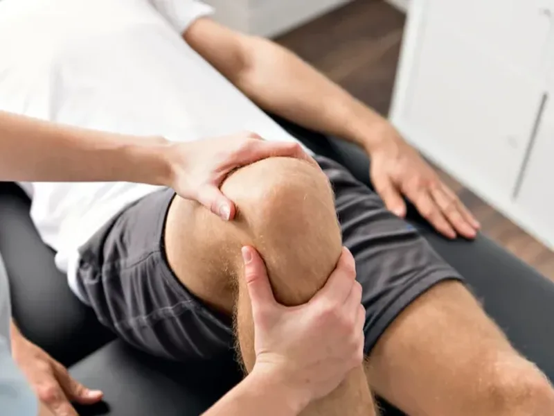 Physical therapist assessing hip and knee mechanics