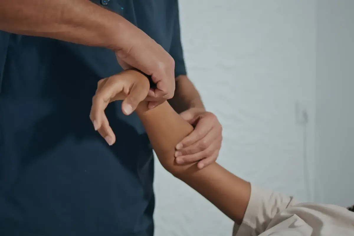 Therapist gripping a patient’s forearm during Active Release Technique