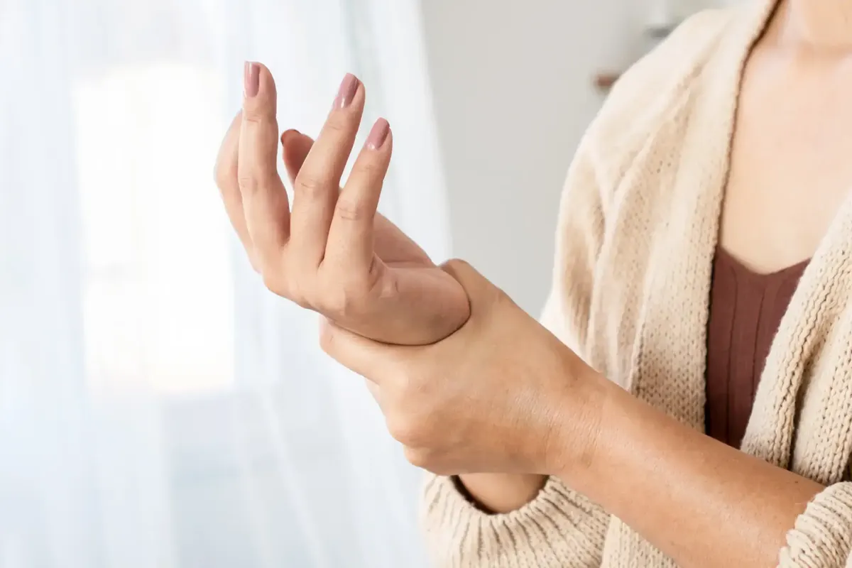 Woman holding her sore wrist
