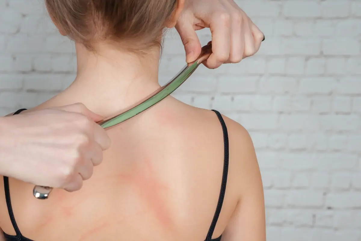 Instrument-assisted soft tissue tool used along a patient’s upper back
